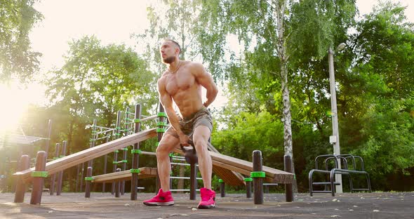 Man Practicing Workout Exercise on Outdoor Sports Ground alt