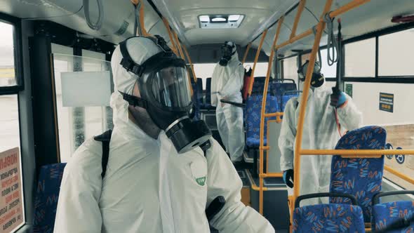 People Spray a Bus with Antiseptics To Kill Coronavirus. alt