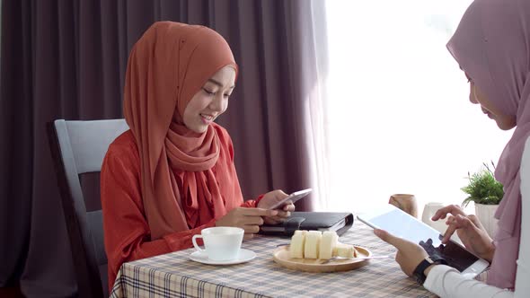 Young muslim woman use smartphone contactless payment in coffee shop