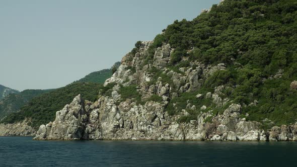 View of the rocky mountains in the open sea alt