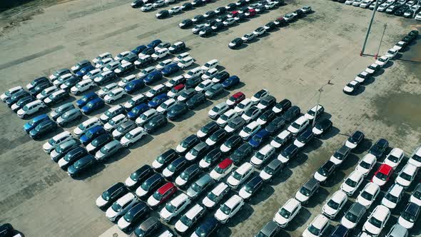 New Cars at a Car Dealer Parking Lot. Aerial Shot. alt