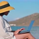 Mature Woman in Hat Using Laptop on Sea Beach - VideoHive Item for Sale