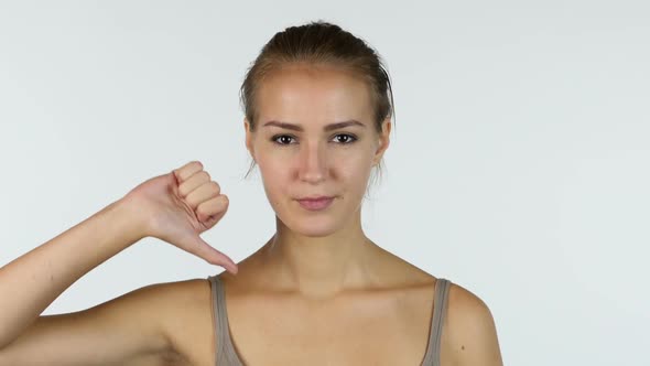 Thumbs Down, Portrait of Successful Beautiful Girl, White Background alt