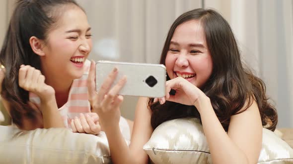 Asian lgbt lesbian couple lying on bedroom.LGBT freedom, alt