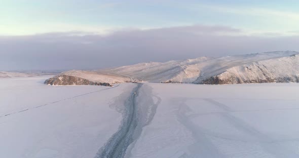 Drone Rises Descends Over Trail Left by a Boat on the Ice of a Frozen Lake alt