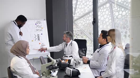 Mixed Race Medical People which Discussing with One Another the Actual Medicine Problems alt