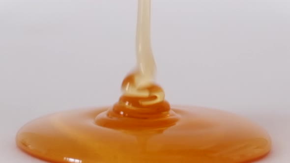 Pouring Honey On White Background