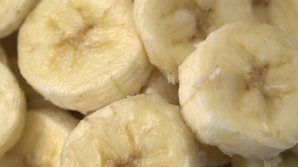 Banana Slices Closeup, Macro Food Summer Background, Fruits Top View. Rotate alt