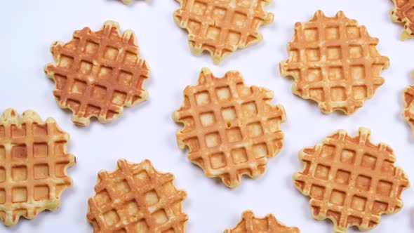 Rotating Background of Appetizing Sweet Waffles on a White Background alt
