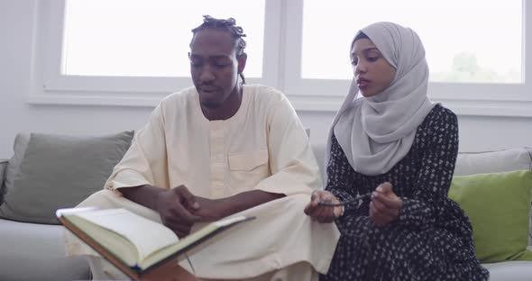 African Muslim Couple at Home in Ramadan Reading Quran Holly Islam Book alt