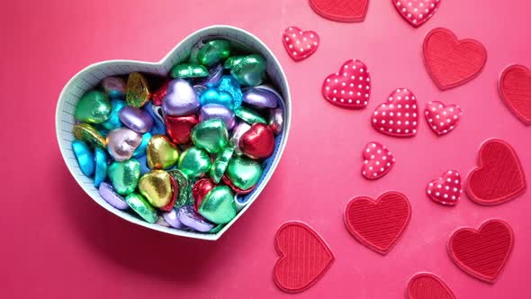 Heart Shape Gift Box with Candy on Red Background  alt