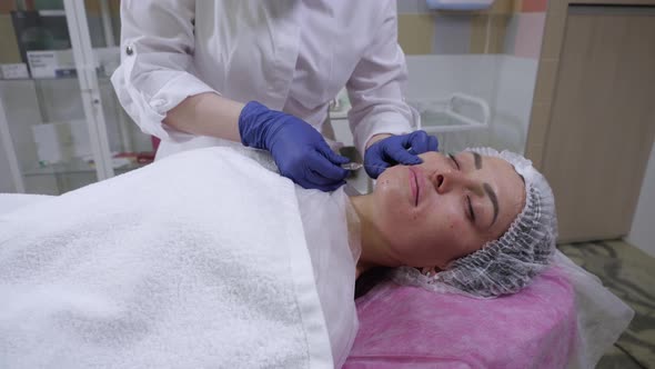 The Beautician Performs the Procedure of Injections Based on Hyaluronic Acid
