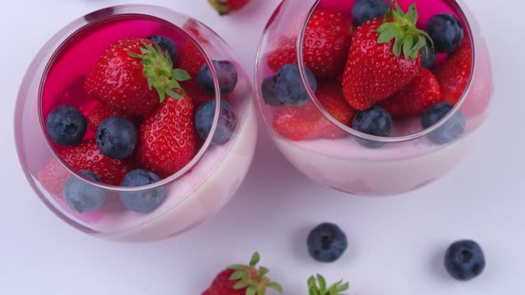 Fruit Jelly Dessert or Panna Cotta with Fresh Strawberries and Blueberries Rotation Top View on
