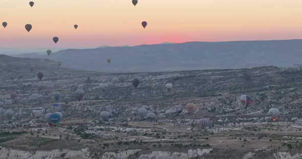 Aerial Cinematic Drone View of Colorful Hot Air Balloon Flying Over Cappadocia alt