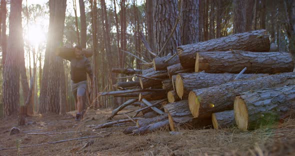 Male Logger Carrying Wooden Log in The Forest 4k alt