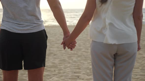 Happy Woman and Man Figures Join Hands on Empty Ocean Beach alt