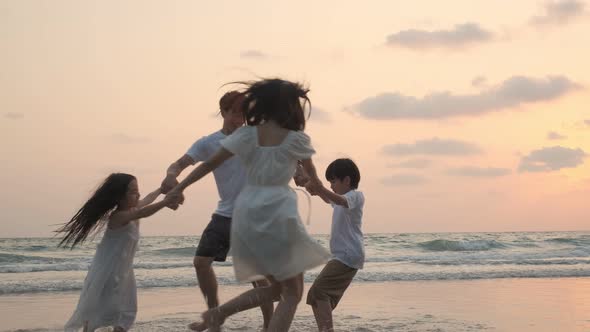 Asian Family playing together at beach with kids happy vacation travel beach concept
