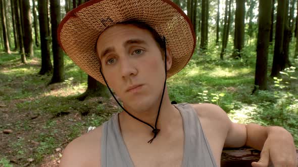 A Guy in a Straw Hat Chats with a Girl in a Blue Shirt Sitting on a Bench