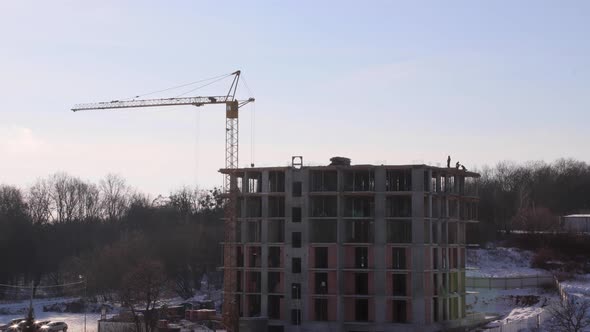 Construction site with big tower crane in time lapse with cloudscape.