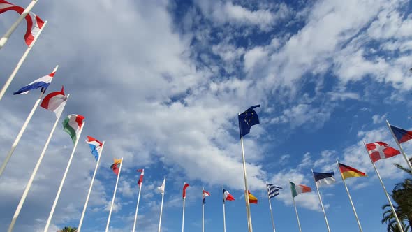 Flags Of European Countries on Flagpoles Against a Cloudy Sky
