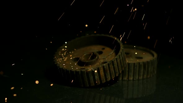 Sparks with gears in ultra slow motion 1500fps on a reflective surface - SPARKS w GEARS  alt