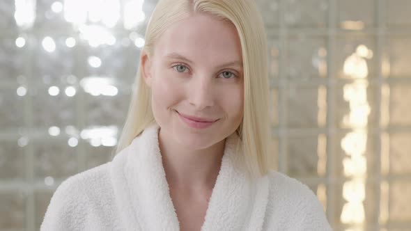 Young Caucasian Woman With Long Blond Hair Wearing a Bath Towel Looking at Camera in a Bright alt
