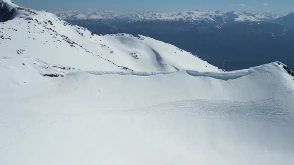 Aerial orbital of Piltriquitron Hil with a snow covered peak, mountains in background, El Bolsón, Pa alt