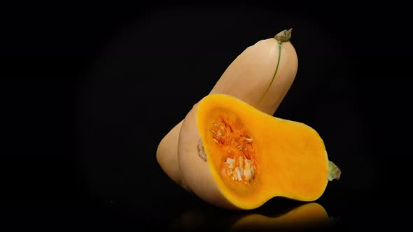 Half Butternut Squash rotation isolated on black background, Close up.