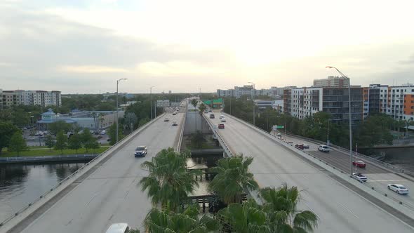 Cars driving on Highway bridge over riverwalk in Tampa, florida alt