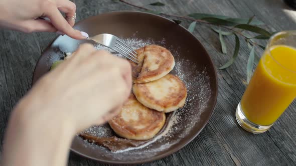 Woman Eating Tasty Pancakes Crepes with Berries on Table Closeup Close alt