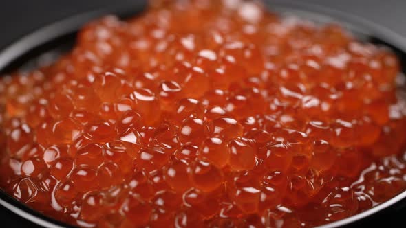 Red Caviar Rotated Over Black Background