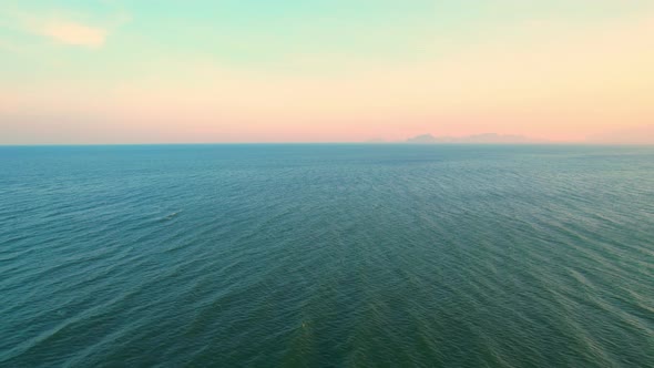 4K Aerial view of drone move on beautiful sea. sunset over ocean waves sand beach. alt