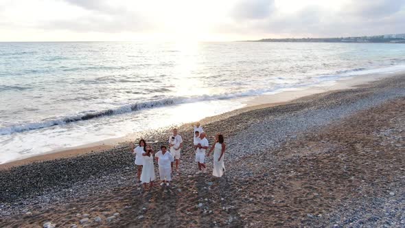 Zoom Out of Group of Multigenerational Asian Family Waving Smiling Standing at Sunset on Picturesque alt
