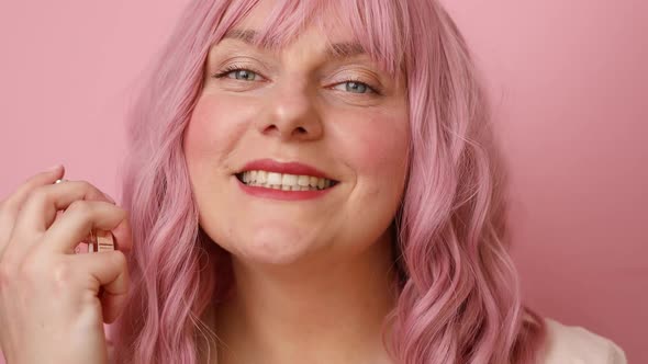 Closeup Portrait of Pretty Young Female with Bottle of Perfume and Applying It alt