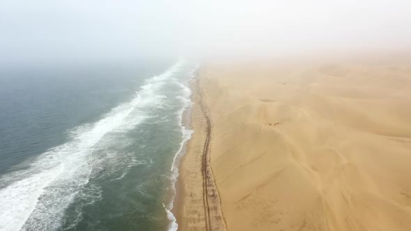 fly-over of the beach on the edge of the Namib desert in Namibia alt