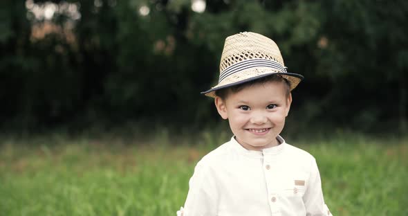 Portrait of a Beautiful Little Boy Laughing and Having Fun in the Park