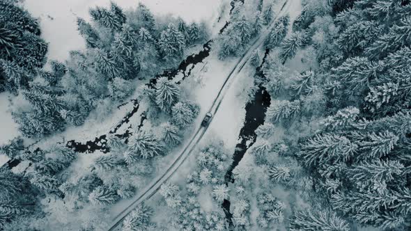 Winter Aerial Footage of a Curved Windy Road Village Cutting Through Mountains Landscape alt