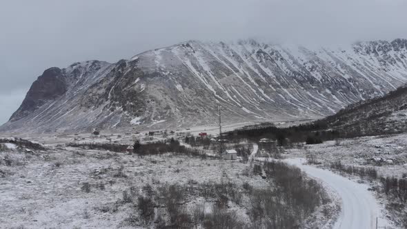 Frozen landscape with snow and ice on the road, a big mountain in the background