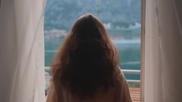 Asian Young Woman Opening Curtain Lace Enjoying Drinking Hot Coffee Tea Watching Views of Sunrise alt