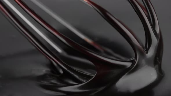 Chocolate. Mixing liquid dark chocolate with whisk