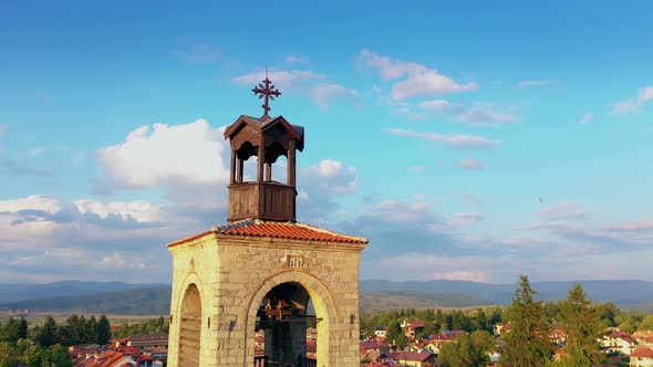Panoramic View Of Bell Tower And Red Rooffs In Beautiful Rustic City In Mountain Region