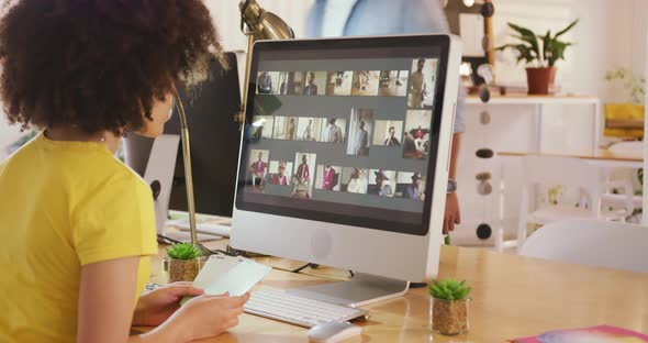 Side view of mixed race woman working in creative office alt