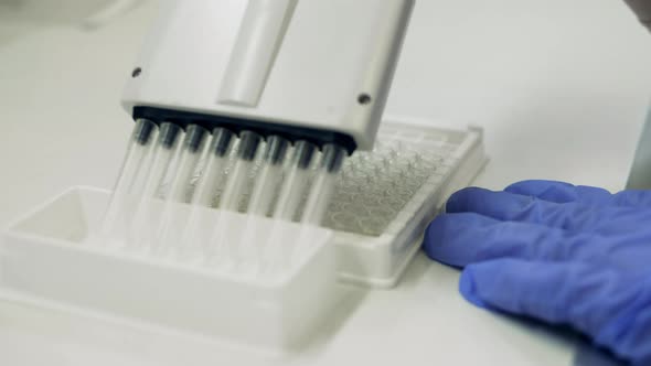 Laboratory Tool Is Being Used To Fill Glass Tubes with Fluids alt