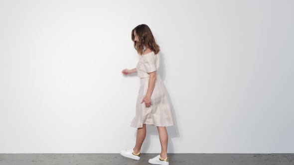 Woman in White Dress Line dancing and Spinning Around while Laughing 