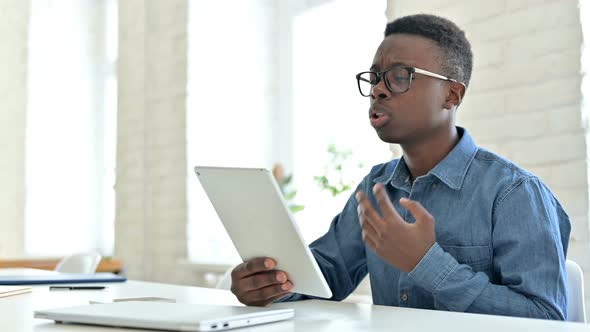 Excited Young African Man doing Video Chat on Tablet alt
