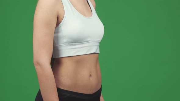 Cropped Shot of a Sportswoman Showing Thumbs Up Holding Water Bottle alt
