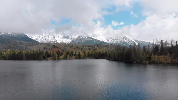 Aerial View of Strbske Pleso, Slovakia. Mountain Lake in Clouds and Snowy Tatras Mountains alt