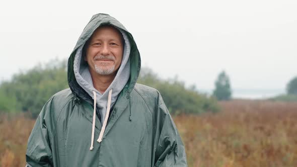 Portrait of a Smiling Elderly Man in Nature Slow Motion