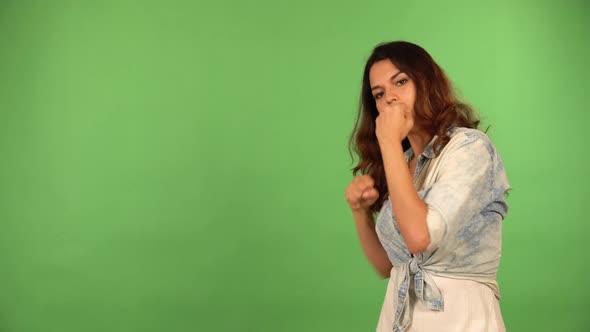 A Young Beautiful Caucasian Woman Boxes with the Camera  Green Screen Background