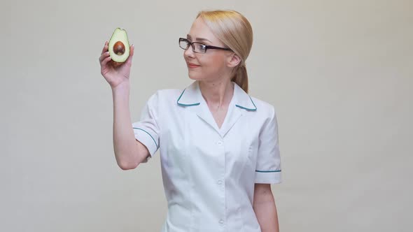 Nutritionist Doctor Healthy Lifestyle Concept - Holding Organic Avocado alt